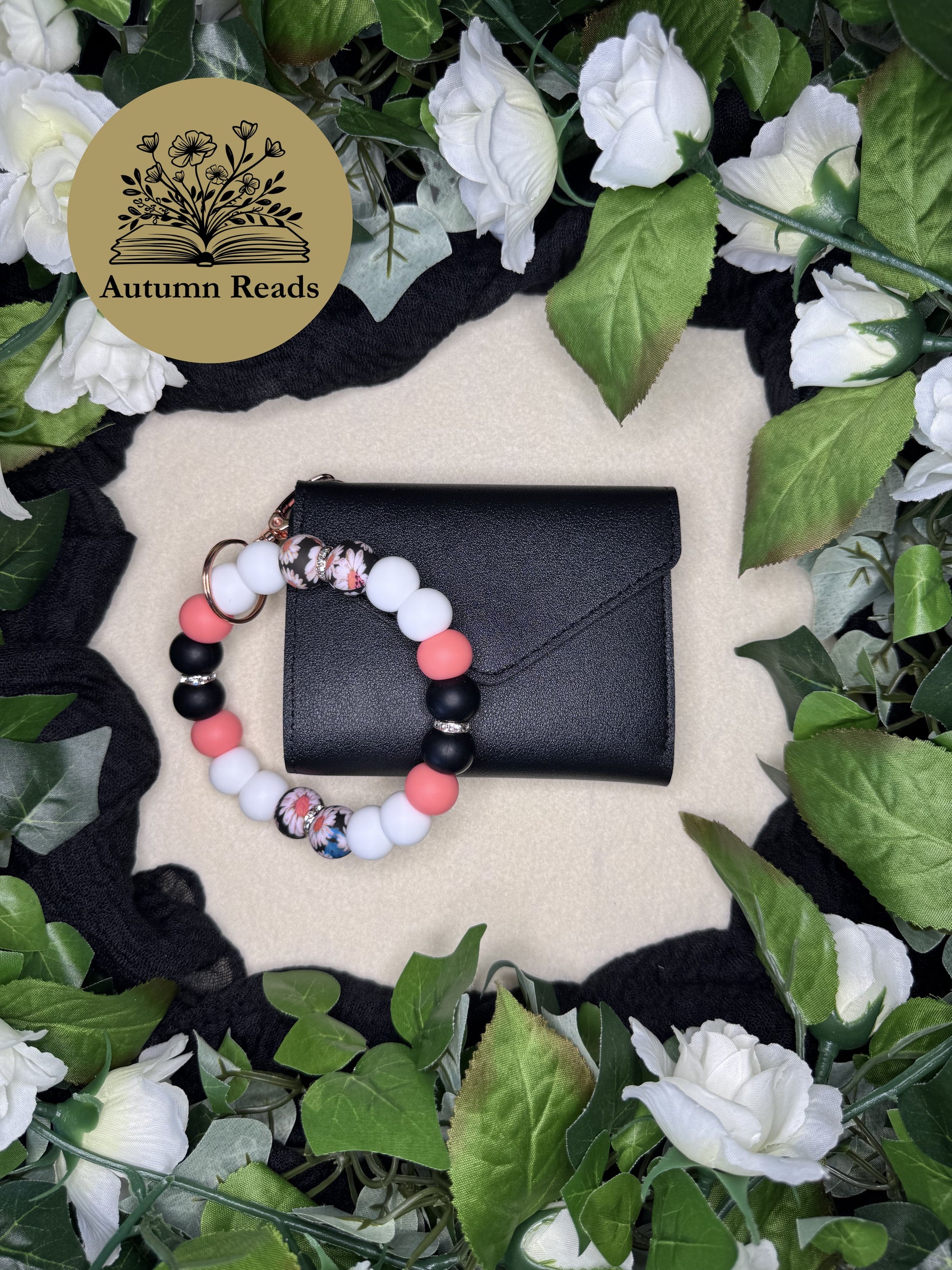 Everyday Daisy handmade beaded keychain paired with a black faux leather wallet by Autumn Reads LLC