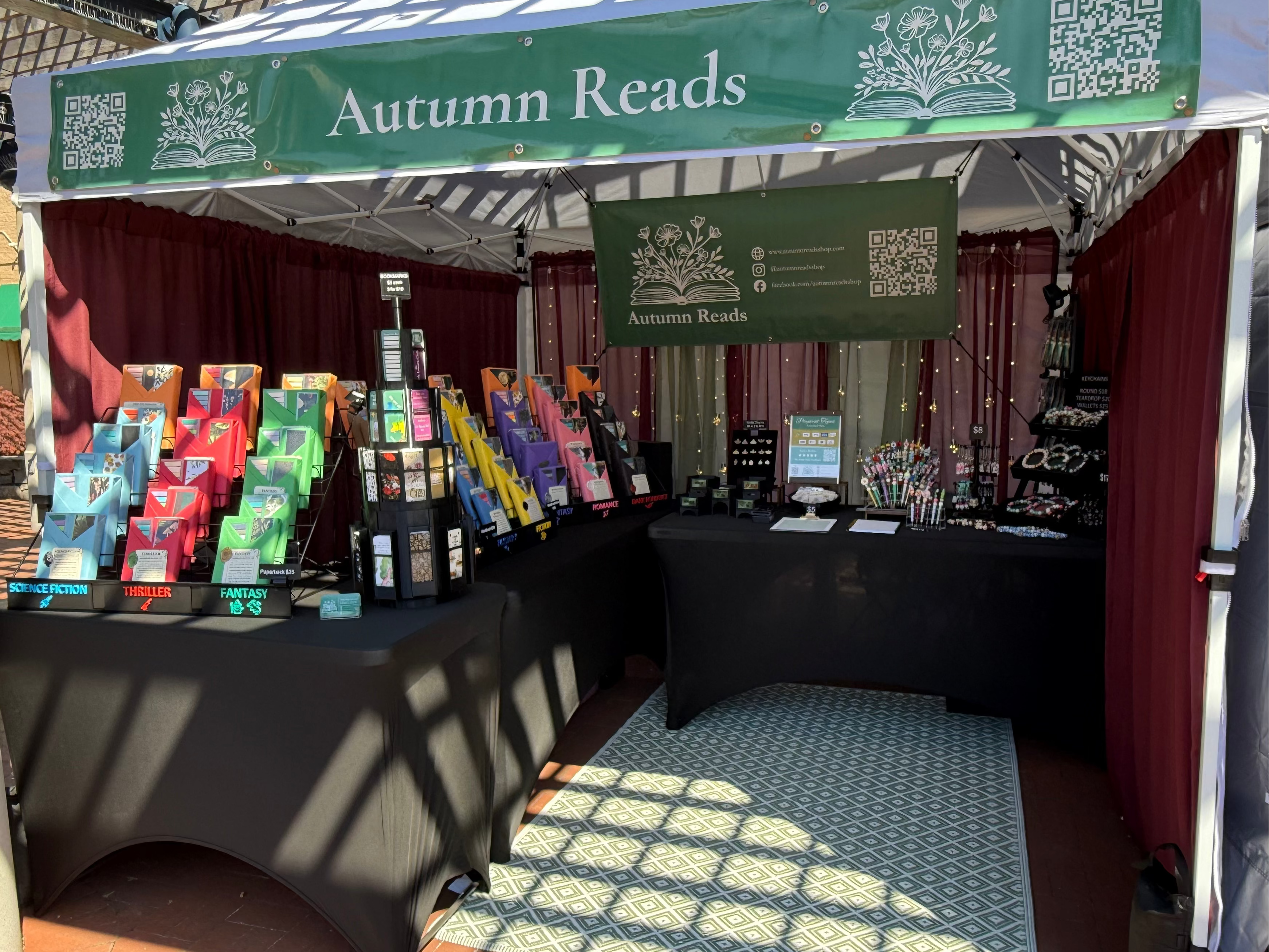 Book stall with 'Autumn Reads' sign at an outdoor event